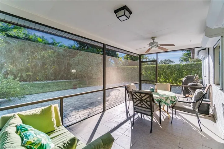 Sunroom featuring outdoor dining space, a ceiling fan, and outdoor lounge area