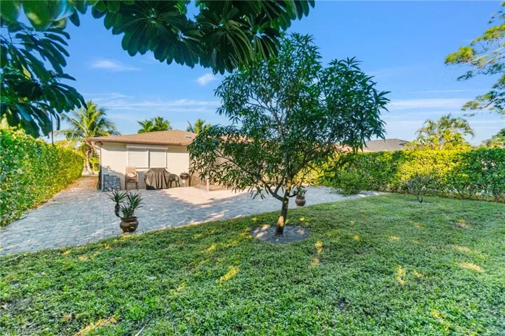 View of grassy yard with a patio area