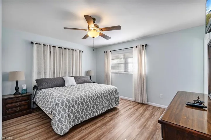 Bedroom with light wood-style floors and a ceiling fan