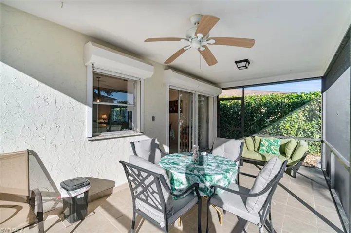 Sunroom / solarium featuring ceiling fan and outdoor dining area