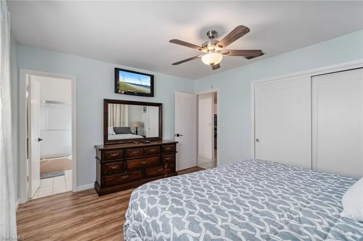 Bedroom featuring light wood-style floors, a ceiling fan, and a closet