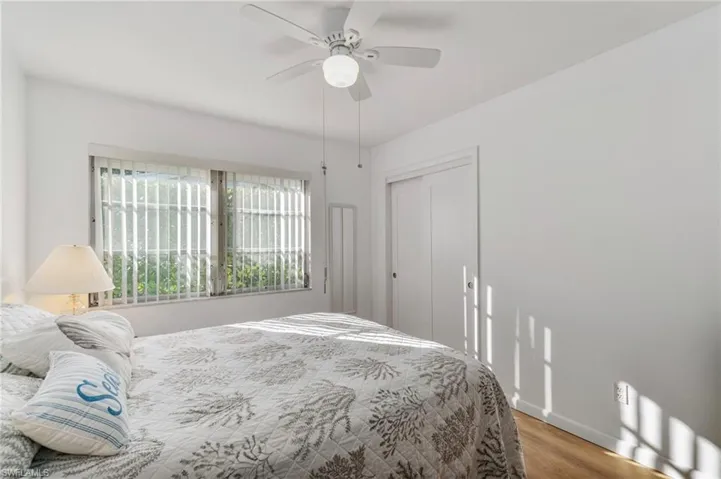 Bedroom featuring wood finished floors, a closet, and a ceiling fan