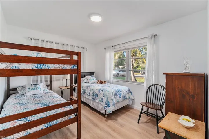 Bedroom featuring light wood finished floors and baseboards