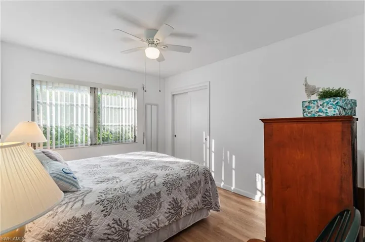 Bedroom with wood finished floors, a closet, and ceiling fan