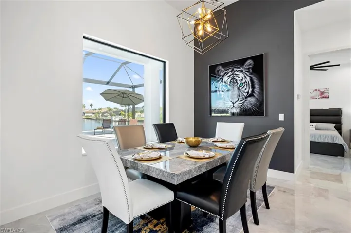 Dining room featuring baseboards and a chandelier