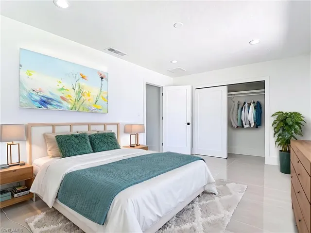 Virtually staged bedroom featuring recessed lighting, light tile patterned flooring, and a closet