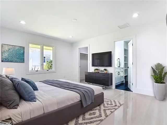Virtually staged bedroom with recessed lighting, a walk in closet, and connected bathroom