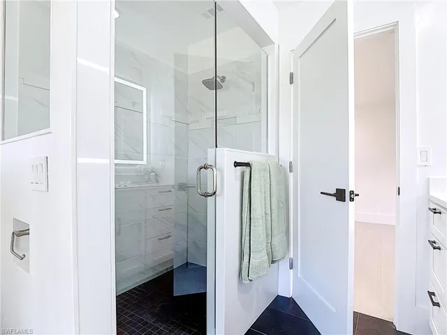 Bathroom featuring a shower stall and vanity