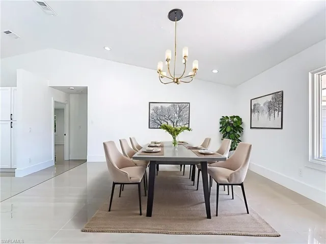 Virtually staged dining area with vaulted ceiling