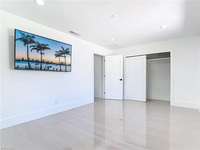 Unfurnished bedroom featuring recessed lighting, light tile patterned flooring, and a closet