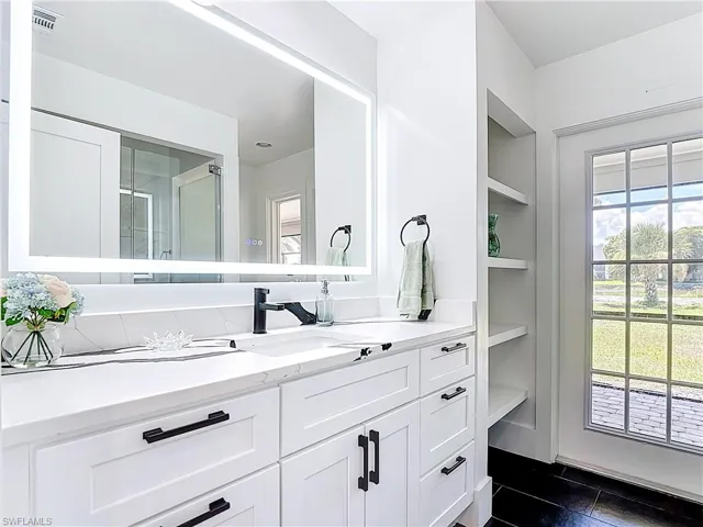 Bathroom featuring vanity and a stall shower