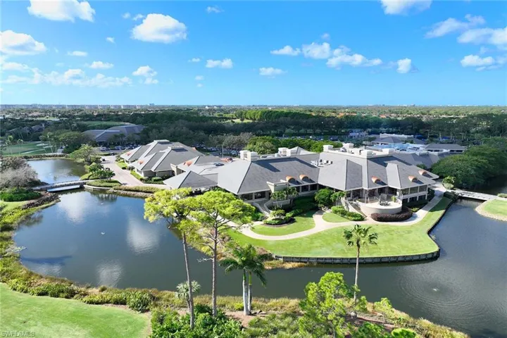 Aerial view of property's location featuring a tree filled landscape and a large body of water