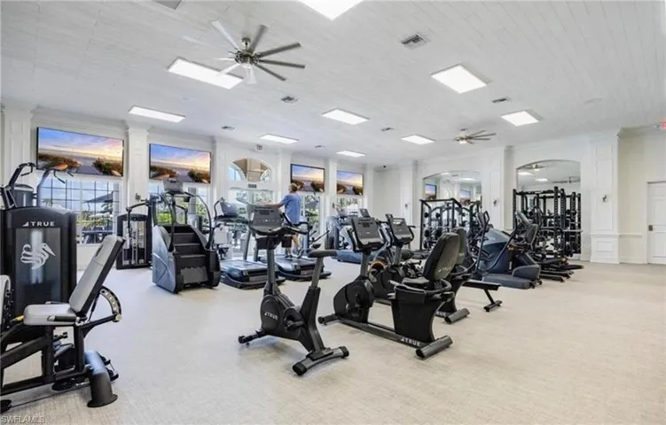 Gym featuring ceiling fan and light colored carpet