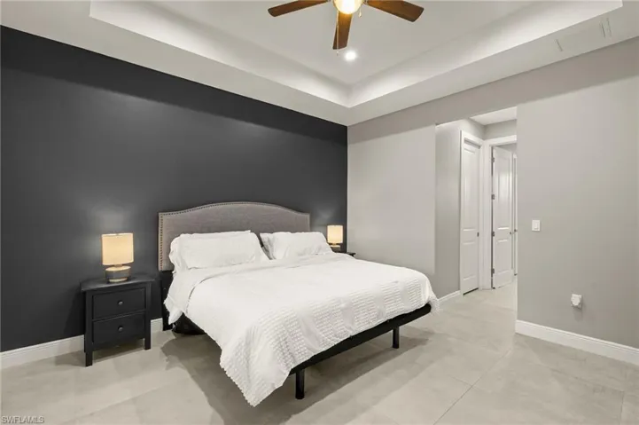 Bedroom featuring visible vents, baseboards, an accent wall, a ceiling fan, and recessed lighting