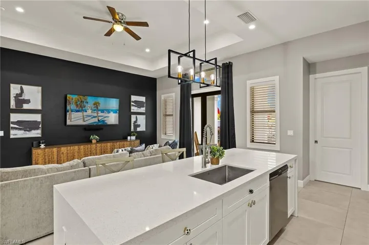 Kitchen featuring recessed lighting, white cabinets, visible vents, dishwasher, and a sink