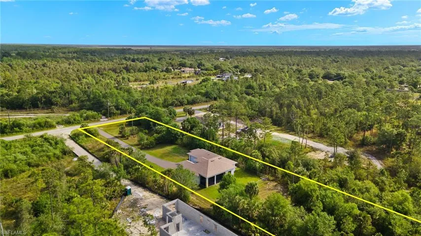 Aerial view featuring a forest view