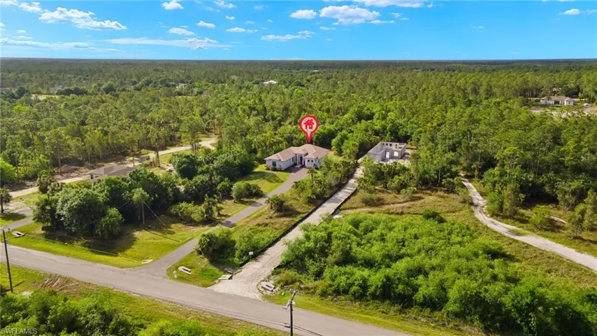 Aerial view featuring a forest view