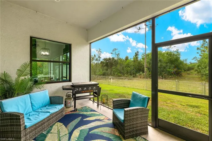 Sunroom / solarium with a chandelier and an outdoor hangout area
