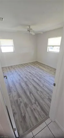 Spare room featuring light wood-type flooring and ceiling fan