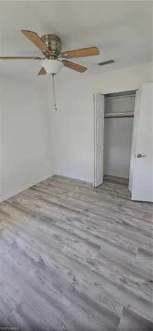 Unfurnished bedroom featuring a closet, light wood-type flooring, and ceiling fan