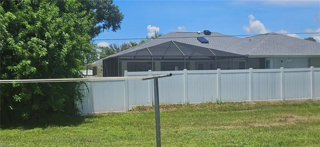 View of yard with glass enclosure