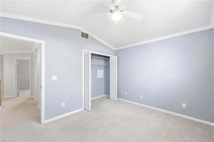 Room featuring neutral carpeting, light blue wall paint, and white trim