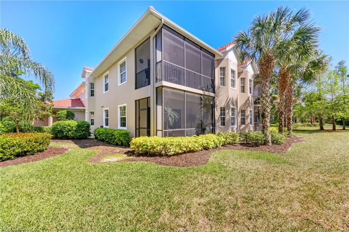 Back of property featuring a sunroom and a yard