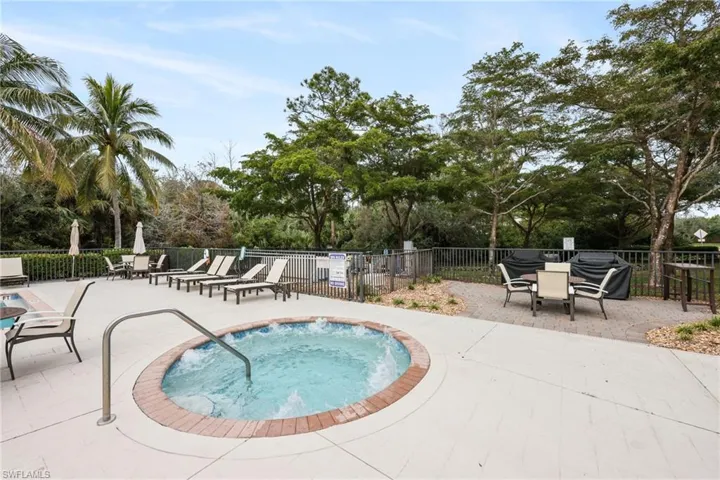 View of swimming pool featuring a community hot tub, area for grilling, and a patio