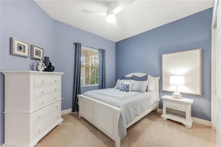 Carpeted bedroom with ceiling fan