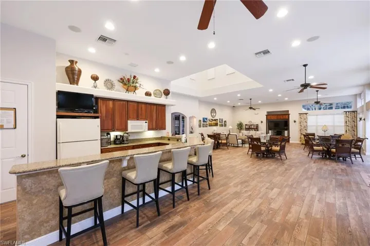 Kitchen, a breakfast bar area, appliances, and light granite counters