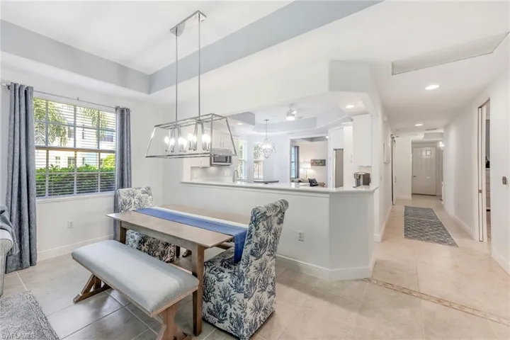 Dining space featuring a raised ceiling and light tile patterned flooring