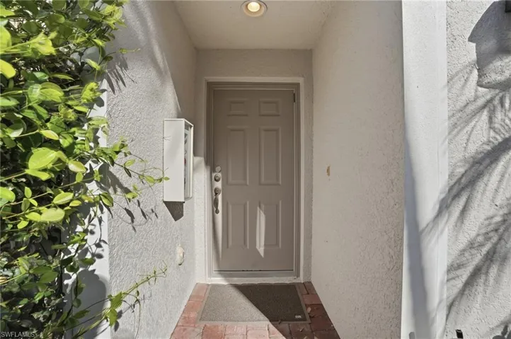 Entrance to property featuring stucco siding