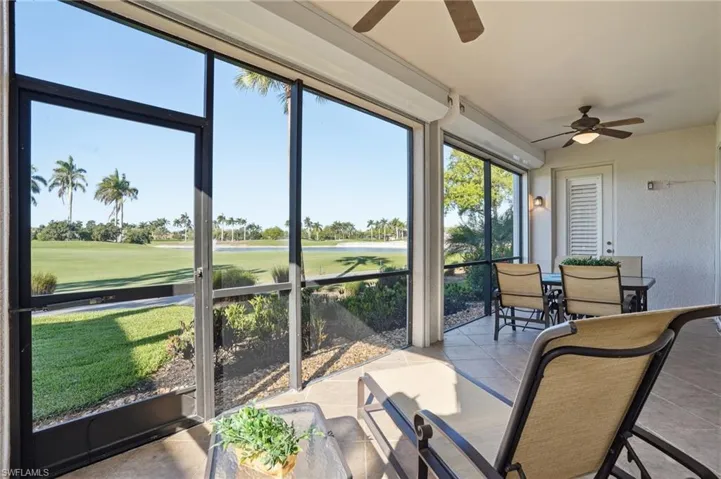 Sunroom featuring ceiling fan, outdoor dining area, and view of golf course