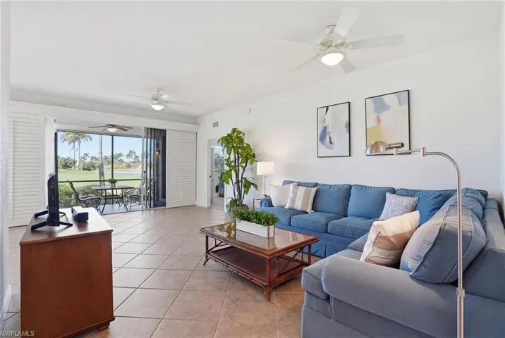 Living area featuring ceiling fan and light tile patterned floors