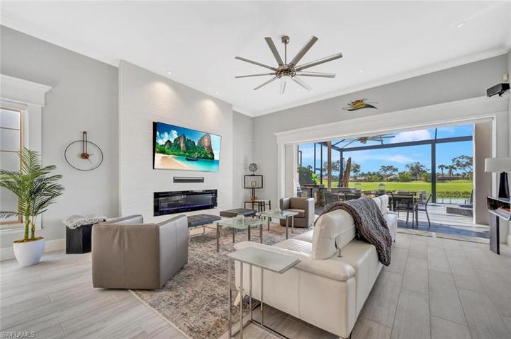 A Wave Tile accent wall, built in fireplace, large screen TV, crown molding  and sliders to the Lanai