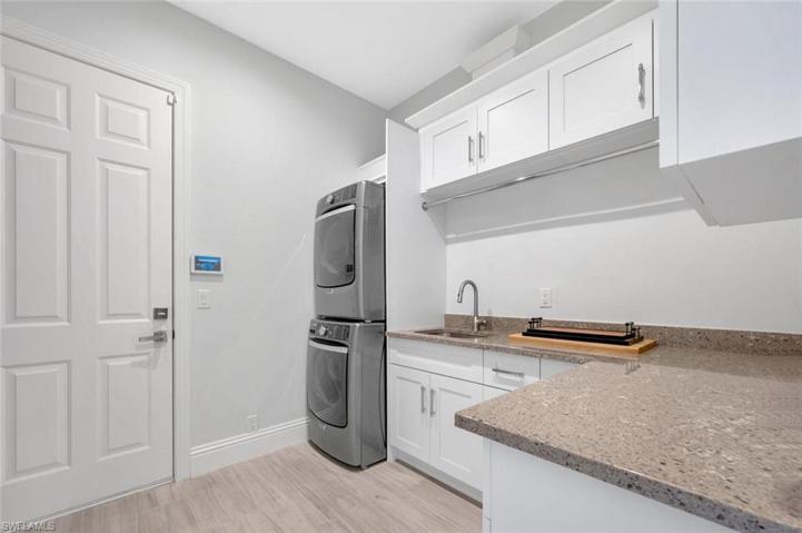 In house Laundry with stackable full size washer and dryer, sink and great storage space. There is also a built in drying rack and ironing board with iron.