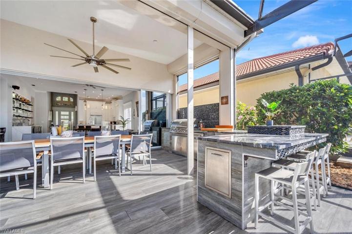 Built in Grill, bar seating area, cabinet storage and custom tile work.