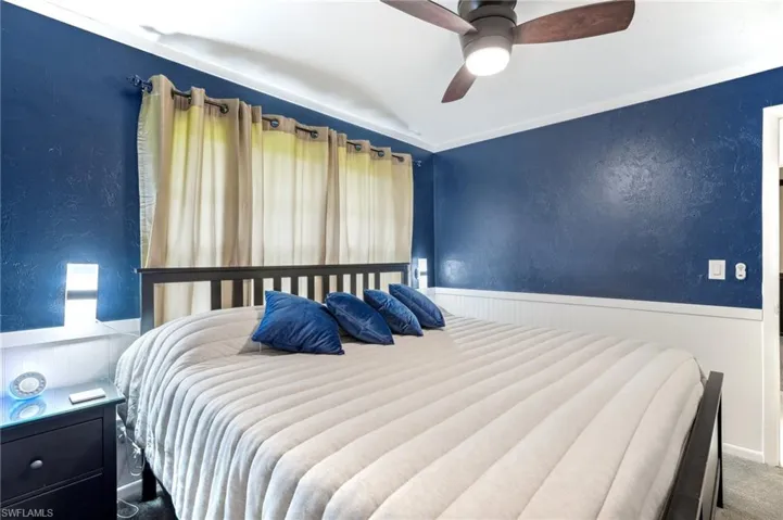 Carpeted bedroom with ceiling fan