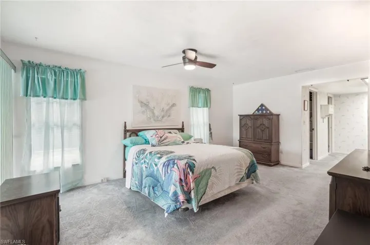 Carpeted bedroom with ceiling fan