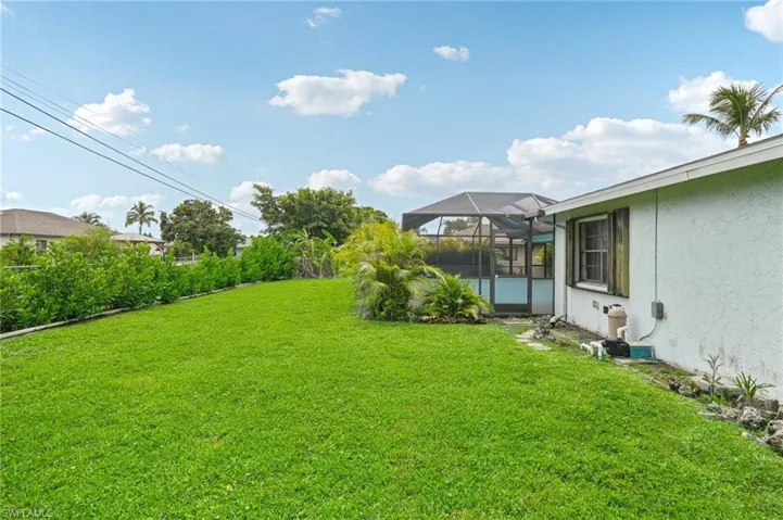 View of yard with a lanai