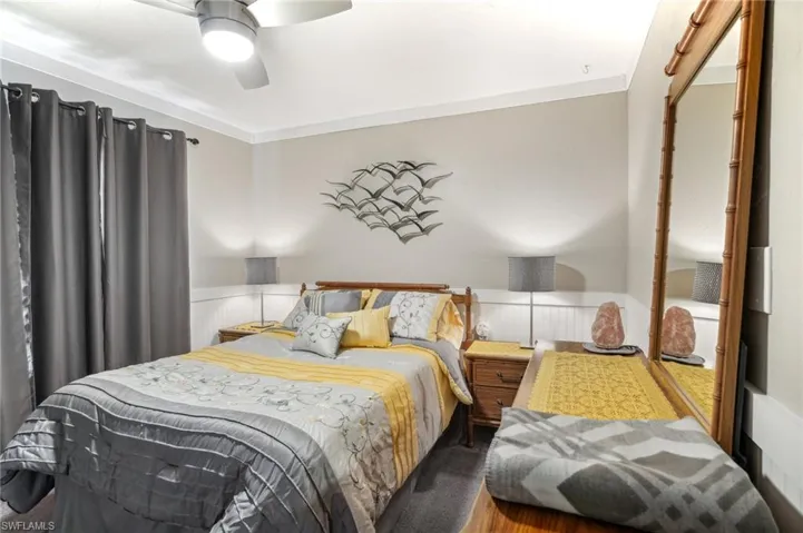 Bedroom featuring crown molding, hardwood / wood-style flooring, and ceiling fan