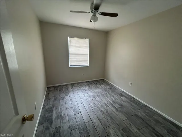 Unfurnished room featuring wood finish floors and ceiling fan