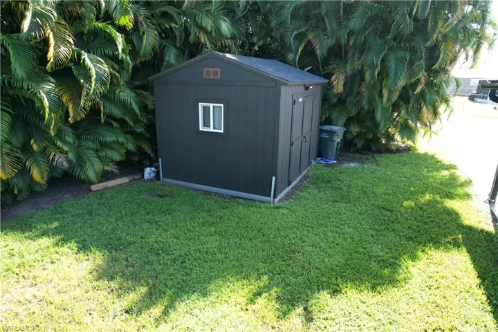 View of outbuilding with a yard