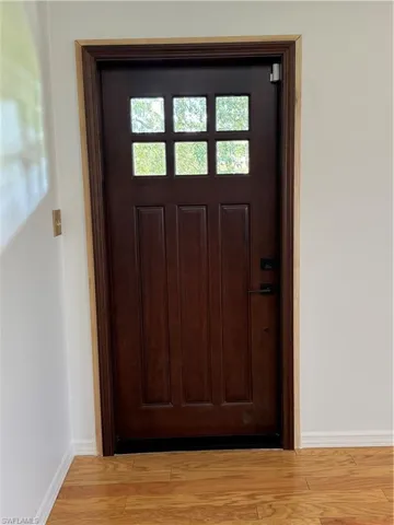 Foyer entrance with light hardwood / wood-style floors and a healthy amount of sunlight