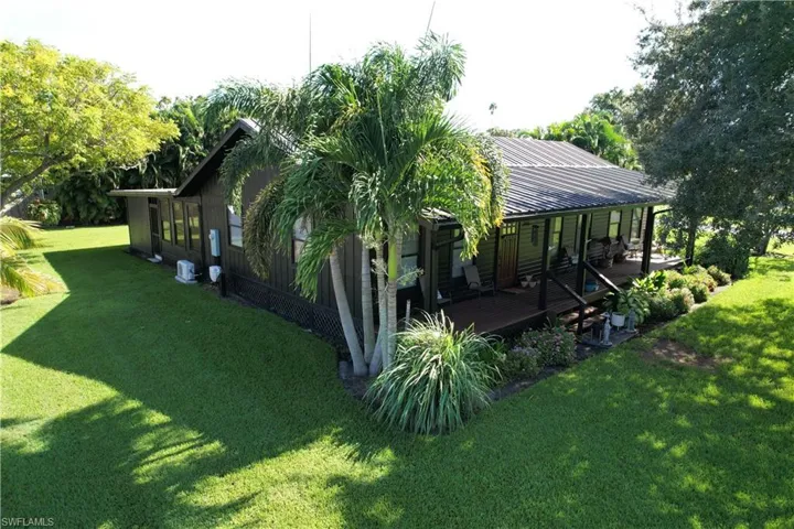 View of side of home featuring a lawn