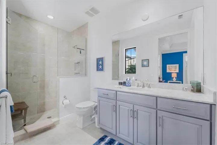 Bathroom featuring a shower stall, vanity, and recessed lighting