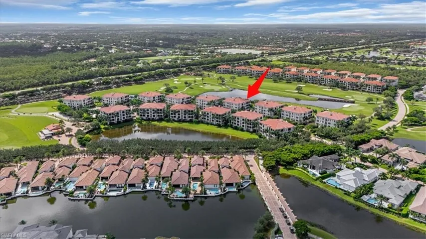 Aerial view of property and surrounding area with nearby suburban area and a nearby body of water