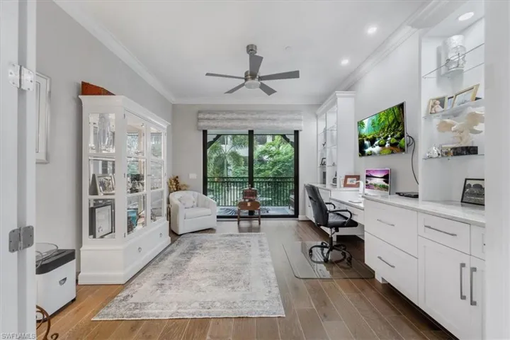 Office space with built in study area, crown molding, a ceiling fan, wood finished floors, and recessed lighting