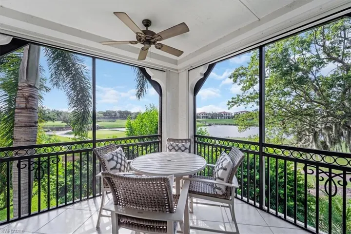 Sunroom with a ceiling fan, a water view, and healthy amount of natural light