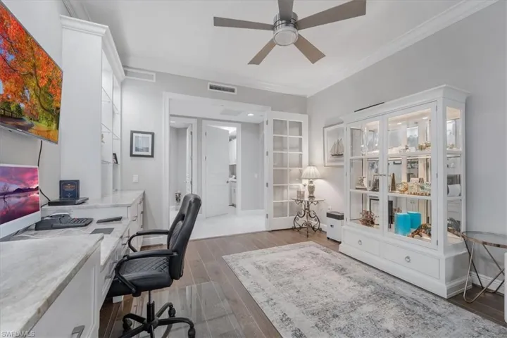 Office area featuring ceiling fan, crown molding, and wood finished floors